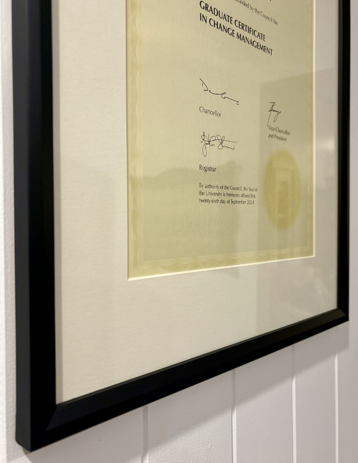 University degree certificate in a black frame with a wide cream conservation mat