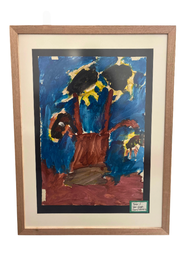A Year 1 child’s painting framed in natural timber with a cream mat