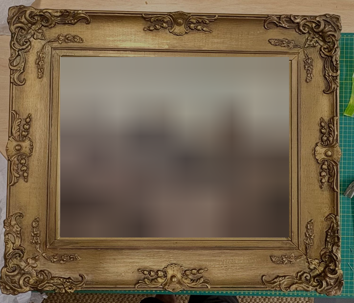 The restored gilt frame back around its painting of soldiers and horses