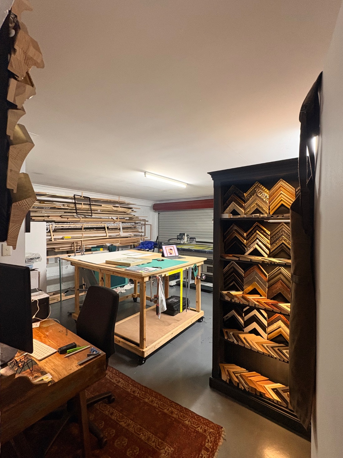 The Framehouse workshop — moulding samples and framing bench, Brookfield