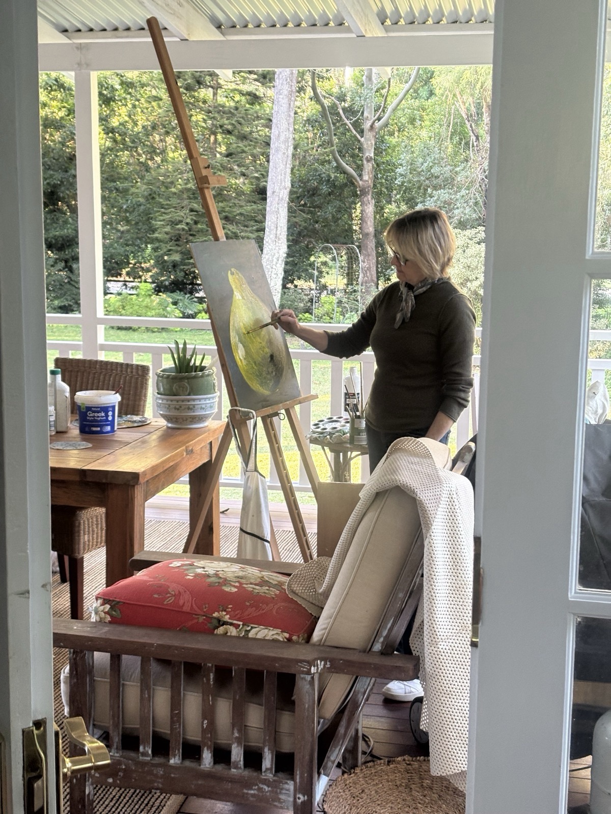 Lois Nicholls painting a still life in acrylic on board at her home studio, Brookfield